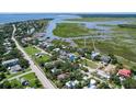 Breathtaking aerial view of a waterfront community with lush green landscapes, winding waterways and multiple boat docks at 1714 Middle St, Sullivans Island, SC 29482