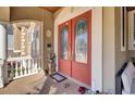 Charming front porch with red double doors, potted plants, and cozy seating at 1739 Indigo Island Dr, Hanahan, SC 29410