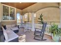 Inviting covered front porch with comfortable seating, rocking chairs, and elegant columns at 1739 Indigo Island Dr, Hanahan, SC 29410