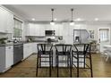 Bright kitchen with a center island, barstool seating, and sleek appliances at 19 N Enston Ave, Charleston, SC 29403