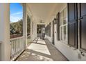 Inviting porch with rocking chairs, black shutters, and bright white columns at 2028 Ironstone Aly, Charleston, SC 29407