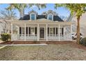 Charming two-story home with a welcoming front porch, white pillars and classic black shutters at 2461 Fulford Ct, Mount Pleasant, SC 29466