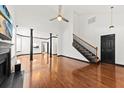 Bright living room featuring hardwood floors, tall ceilings, and a staircase to the upper level at 2461 Fulford Ct, Mount Pleasant, SC 29466