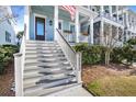 Inviting front porch features classic columns, flowering baskets, and a clear view of the house number at 2552 Josiah St, Daniel Island, SC 29492