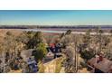 Stunning aerial view of the home nestled amongst lush trees near the water at 316 Anadale Ct, North Charleston, SC 29418