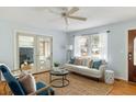 Cozy living room filled with natural light, ceiling fan, and comfortable seating at 3501 Hartnett Blvd, Isle of Palms, SC 29451