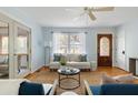 Bright living room featuring hardwood floors, a ceiling fan, and a view to the exterior at 3501 Hartnett Blvd, Isle of Palms, SC 29451
