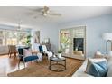 Open-concept living room with access to the dining area and lots of natural light at 3501 Hartnett Blvd, Isle of Palms, SC 29451