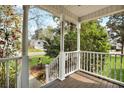 Covered front porch with white railing offering a glimpse of the neighborhood at 3545 Rookwood Pl, Johns Island, SC 29455