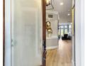 Bright foyer featuring hardwood floors, neutral paint, and a view into the living area at 3608 Maidstone Dr, Mount Pleasant, SC 29466