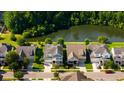 An aerial view of a beautiful neighborhood showcasing well-maintained homes, lush greenery, and a serene pond at 3664 Maidstone Dr, Mount Pleasant, SC 29466