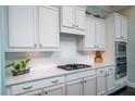 Modern kitchen features white cabinets, stainless steel appliances, and quartz countertops for a clean, elegant look at 3664 Maidstone Dr, Mount Pleasant, SC 29466