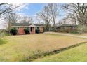Charming single-story brick home with a long driveway and a well-manicured lawn with mature trees at 4203 Marilyn Dr, North Charleston, SC 29418