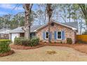 Lovely single-story brick home with blue shutters, surrounded by well-maintained landscaping at 4604 Garwood Dr, Ladson, SC 29456