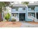 Charming blue condo with covered parking, a well-kept lawn, and a welcoming entrance at 482 Sea Cloud Cir, Edisto Island, SC 29438
