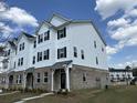 View of three-story townhouse with siding, brick facade and new construction at 5126 Double Eagle, Summerville, SC 29485