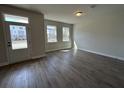 Living room with ample sunlight, wood floors, and view of neighborhood at 5126 Double Eagle, Summerville, SC 29485