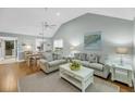 Bright living room featuring vaulted ceilings, hardwood floors, and comfortable furnishings at 626 Double Eagle Trce, Johns Island, SC 29455