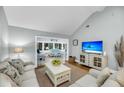 Cozy living room with a view to sunroom, with neutral decor and vaulted ceiling at 626 Double Eagle Trce, Johns Island, SC 29455