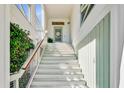 A bright and airy entryway featuring a white staircase and an inviting glass door with a decorative wreath at 744 Gate Post Dr, Mount Pleasant, SC 29464
