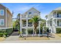 Charming, multi-story beach home featuring a landscaped yard, side car port and cross beam railings at 744 Gate Post Dr, Mount Pleasant, SC 29464