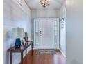 Bright foyer with elegant wood flooring, stylish console table, and shiplap accent wall at 7720 Kinston St, North Charleston, SC 29418
