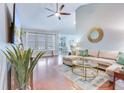 Cozy living room featuring hardwood floors, a comfortable sectional sofa, and a modern ceiling fan at 7720 Kinston St, North Charleston, SC 29418