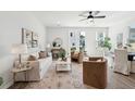 Spacious living room featuring a ceiling fan, a sofa, chairs, and natural light at 830 Alma Square Dr, Moncks Corner, SC 29461