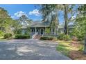Charming home with large front porch, brick stairs and lush landscaping at 8704 Middleton Point Ln, Edisto Island, SC 29438