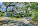 Beautiful home with mature landscaping and circular driveway at 8704 Middleton Point Ln, Edisto Island, SC 29438