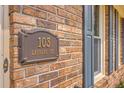 Close up showing the property address on a decorative plaque at 103 Laurens Ct, Summerville, SC 29485