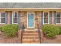 Close-up of the brick steps and front door featuring blue paint and an address plaque at 103 Laurens Ct, Summerville, SC 29485