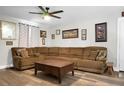 Cozy living room with a large sectional sofa, ceiling fan, and decorative wall art at 103 Sprucewood Dr, Summerville, SC 29485
