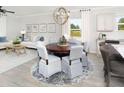 Open-concept living room with a dining area, modern lighting, and ample natural light at 116 Royal Cainhoy Way, Huger, SC 29450
