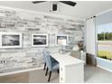 Bright office featuring a decorative wall, light wood floors, and a large window at 116 Royal Cainhoy Way, Huger, SC 29450