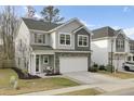 Inviting two-story home with stone accents and a well-manicured lawn at 1161 Triple Crown Ct, Mount Pleasant, SC 29429