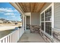 Inviting covered porch featuring stone accents and a view of the neighborhood at 126 Lakelyn Rd, Moncks Corner, SC 29461