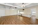 Spacious living room featuring wood floors, ceiling fans, built-in cabinets and shelving, and neutral wall colors at 1308 Coleridge St, Charleston, SC 29407