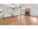 Comfortable living room with wood floors, white ceiling beams, a brick fireplace, and built-in cabinets at 1308 Coleridge St, Charleston, SC 29407