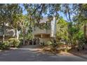 Inviting raised beach home featuring neutral siding and lush landscaping at 1409 Dune Loft Villas, Seabrook Island, SC 29455