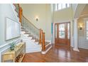 Elegant foyer featuring a grand staircase, high ceilings, and beautiful hardwood floors at 1427 Shell Fish Ct, Mount Pleasant, SC 29466