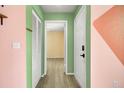 Hallway featuring light wood flooring, neutral walls and white doors at 1481 Center Street Ext # 601, Mount Pleasant, SC 29464