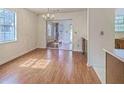 Dining room features hardwood floors and a chandelier with sliding glass doors at 158 Commons Way, Goose Creek, SC 29445