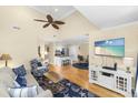 Cozy living room with hardwood floors, beach-themed rug, and comfortable seating area at 1638 Live Oak Park, Seabrook Island, SC 29455