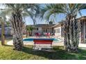 Relaxing backyard pool with patio seating, perfect for outdoor entertaining surrounded by palm trees at 1886 Capri Dr, Charleston, SC 29407
