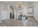 Well-equipped kitchen featuring granite countertops, a black oven, and ample white cabinetry at 191 Blackstone Dr, Moncks Corner, SC 29461