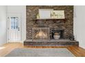 Classic brick fireplace featuring detailed screen, mantle, and decor at 203 Horseshoe Rd, Moncks Corner, SC 29461