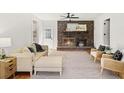 Cozy living room with a brick fireplace, hardwood floors, and neutral decor at 203 Horseshoe Rd, Moncks Corner, SC 29461