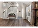 Welcoming foyer with hardwood floors, white staircase, and stylish console table at 2915 Nantuckett Ave, North Charleston, SC 29420