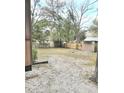 Spacious backyard with mature trees, fenced perimeter, and storage shed, offering a private outdoor retreat at 313 Springwood Dr, Walterboro, SC 29488